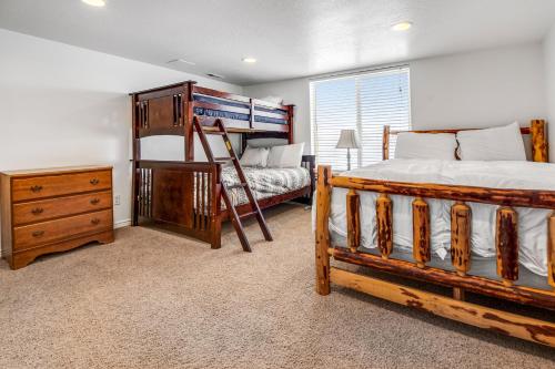 a bedroom with two bunk beds and a dresser at Harbor Village Retreat in Garden City