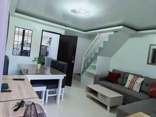 a living room with a couch and a table at 4 - Affordable 2-Storey House in Cabanatuan City in Cabanatuan