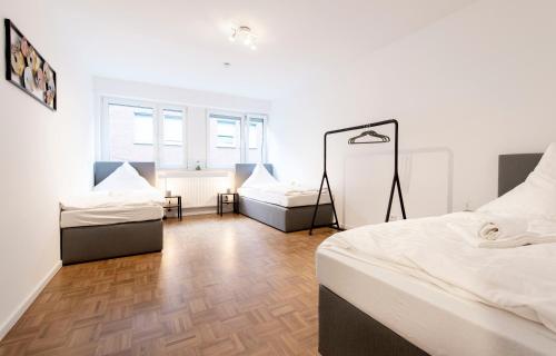 a bedroom with two beds and a mirror at Stay and Work Apartment - 6 single beds in Bocholt