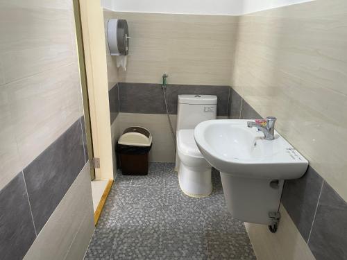a small bathroom with a sink and a toilet at Summer room B in Dumaguete