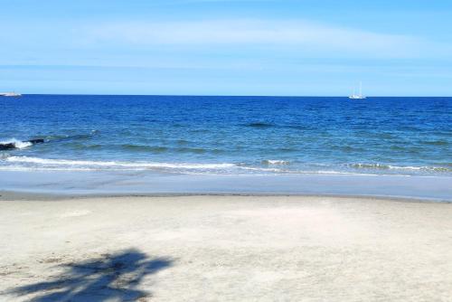 a shadow of a person on the beach at Hotel City Piriápolis in Piriápolis