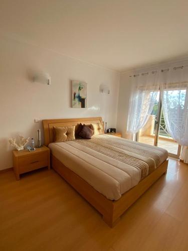 a bedroom with a large bed in a room at Balaia Residence in Albufeira