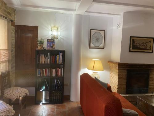 a living room with a couch and a fireplace at CASA MIRIAM in La Iglesuela del Cid