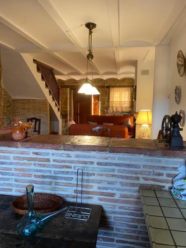 a living room with a brick wall with a sink at CASA MIRIAM in La Iglesuela del Cid