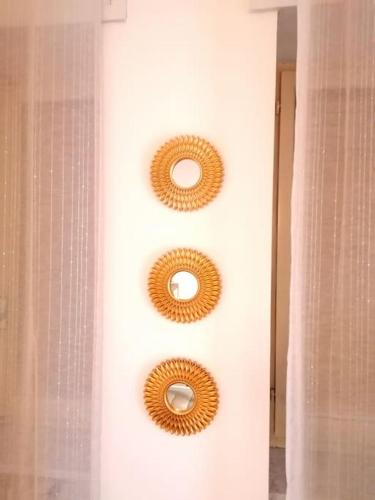 two mirrors hanging on a wall in a bathroom at Vercelli suite in Borgo Vercelli