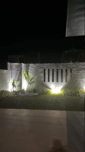 a stone wall with lights on it at night at Seafront Residences Vacation Getaway in San Juan