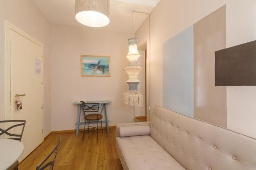 a living room with a couch and a table at Aurora Boutique Hotel & Private SPA in Spoleto