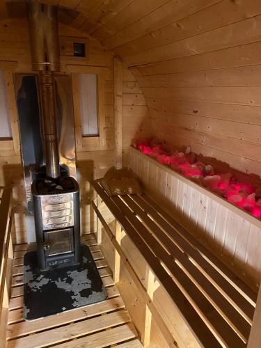 an inside of a wooden cabin with a stove at Dolina Wisełka in Wisełka