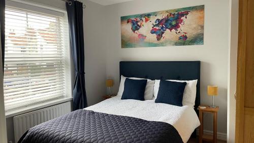 a bedroom with a bed and a painting on the wall at The Haven in Hornsea Town Centre in Hornsea