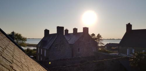 une vieille maison au soleil en arrière-plan dans l'établissement Au 3 La Cour à Tôt, à Regnéville-sur-Mer