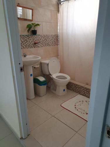 a bathroom with a toilet and a sink at Margarita in Río San Juan