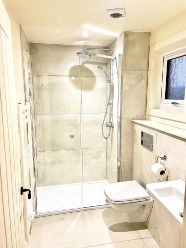 a bathroom with a shower and a toilet and a sink at The Old Croft in Fort Augustus