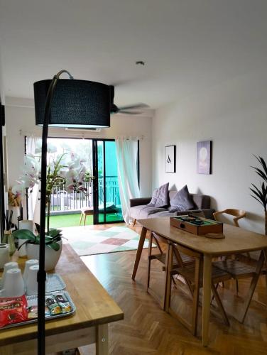 a living room with a table and a couch at EMIRA RESIDENT in Shah Alam