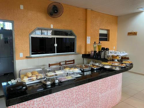 a buffet line with many different types of pastries at Raludi Hotel in Barcarena