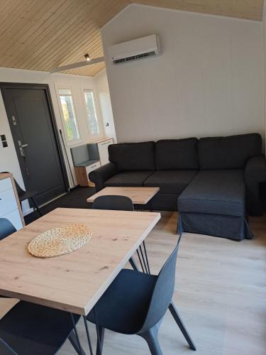a living room with a couch and a table and chairs at Samostatný domek SRDCOVKA in Dolní Morava