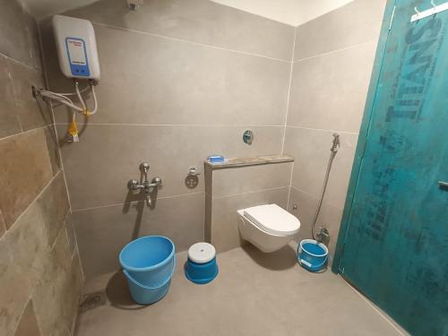 a small bathroom with a toilet and a shower at Osaree Agro and Art Hub in Kolhapur