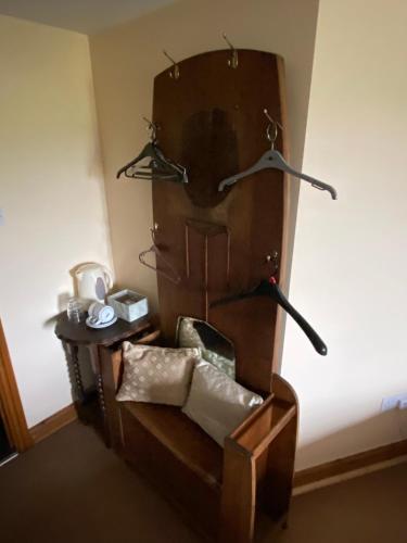 a room with a wooden chair and a table at The crown inn Longtown in Hereford