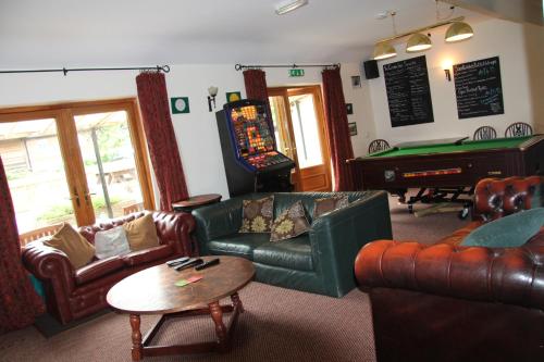 a living room with couches and a pool table at The crown inn Longtown in Hereford