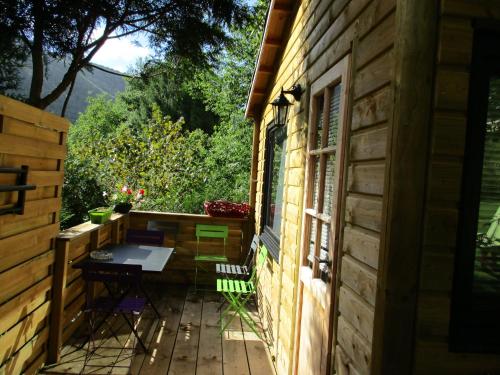 a patio with a table and a window at CHALET Chataigne ETAPEBOISEE in Fumay