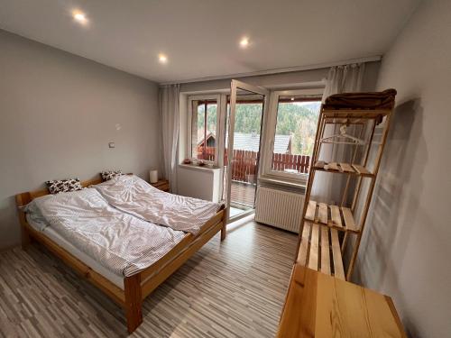 a bedroom with a bed and a ladder at Górski Apartament w Szczyrku in Szczyrk