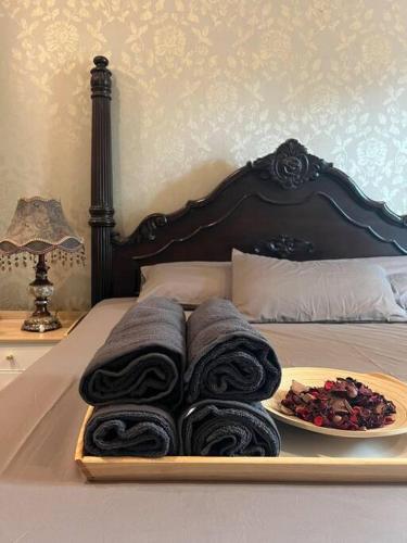 a tray with towels and a plate of food on a bed at Perfect Marina Stay@ Strait Quay 5 pax w/ Free Carpark in Bagan Jermal