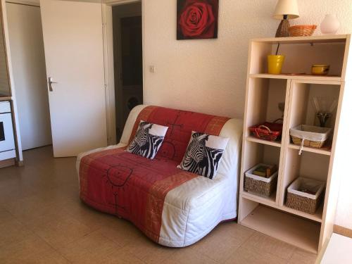 ein Zimmer mit einem Sofa mit Kissen darauf in der Unterkunft Location Vacances entre mer et montagnes in Argelès-sur-Mer