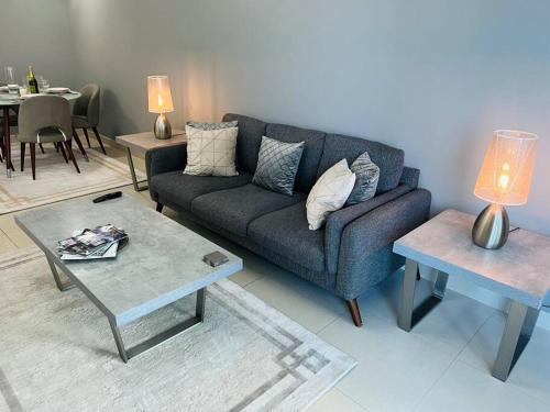 a living room with a couch and a table at Ocean Heights - Spacious 1 Bedroom Apartment with Sea View, Gym & Free Parking in Dubai