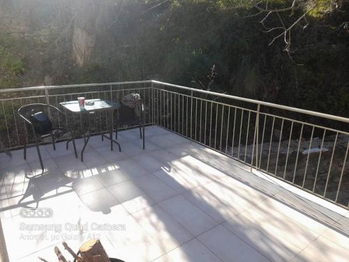a balcony with a table and a fence at Villa Eva I in Nédhousa
