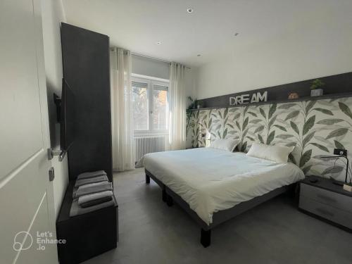 a bedroom with a large bed with a large headboard at R39 Modern Apartment with Private Parking in Milan