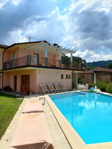 Villa con piscina frente a una casa en Villa Ester en Camaiore