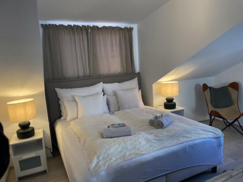 a bedroom with a large bed with two lamps at FREDYs APARTMENTs in Stari Grad