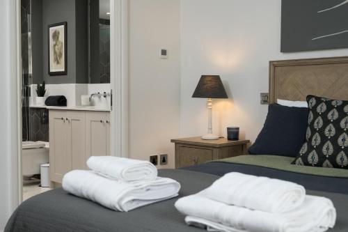 a bedroom with a bed with white towels on it at Bath Penthouse with amazing views and lift access in Bath