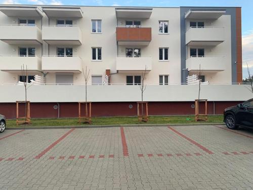 a parking lot in front of a building at Apartament - Brzeska For You in Lubin