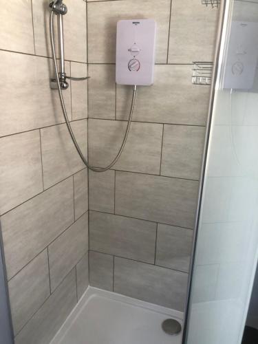 a bathroom with a shower with a glass door at Chequers in Doncaster