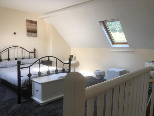 a bedroom with a bed and a staircase with a window at Chequers in Doncaster