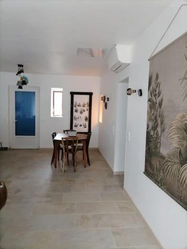 une salle à manger avec une table et un tableau au mur dans l'établissement chez frédérique, à Saint-Trojan-les-Bains