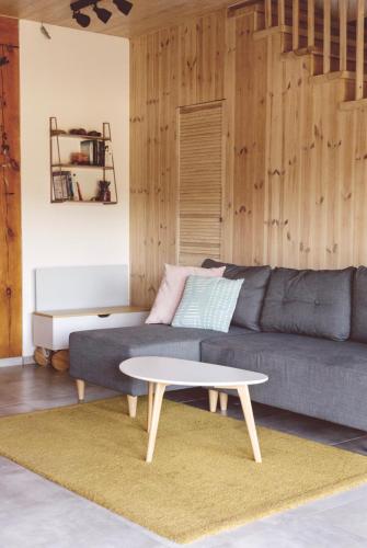 a living room with a couch and a coffee table at Mak i Rumianek in Parzeńsko