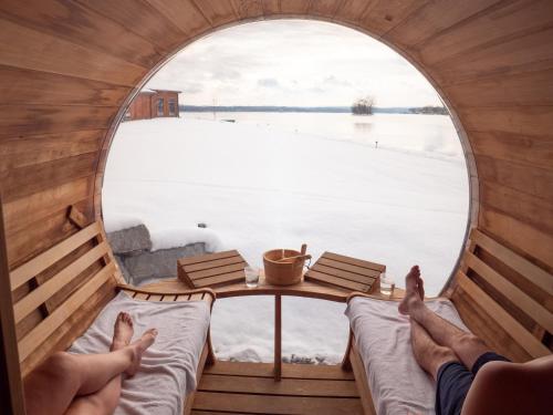 a person with their feet up in a round window looking out at the water at The Lake House on Canandaigua in Canandaigua