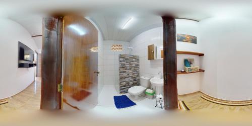 a bathroom with a shower and a toilet in a room at Espaço HaRo in São Miguel do Gostoso