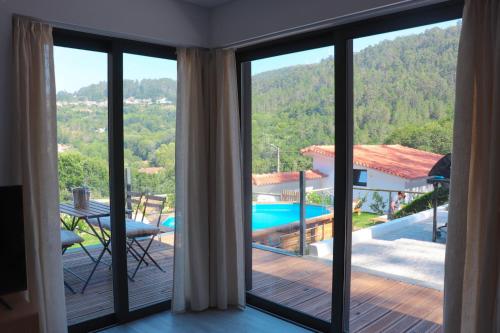 a view from the balcony of a villa with a swimming pool at Bela Vista Urtigosa in Arouca