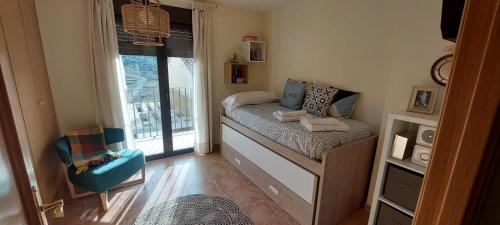 a small room with a bed and a window at El HOGAR DE LAS MARIPOSAS - VUTE-22-057 in Valdelinares