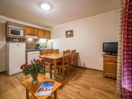 a kitchen and dining room with a table and chairs at Appartement à la Montagne The view in Albiez-Montrond