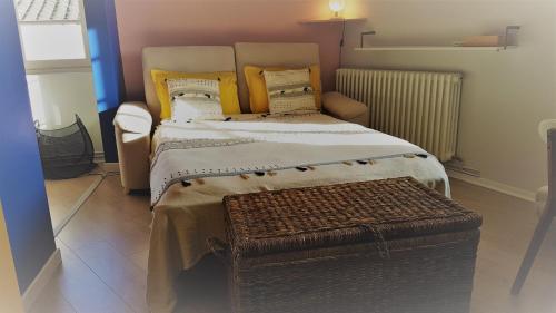a bedroom with a large bed with yellow pillows at Le point de vue in Albi