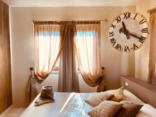 a bedroom with a large clock on the wall at Spazio[Bianco] in Ivrea