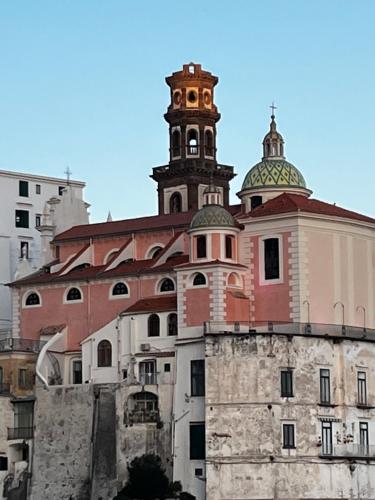 a building with a clock tower on top of it at Casa Angelica in Ravello