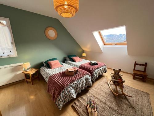 a bedroom with two beds and a window at MAISON DES VIGNES in Embrun