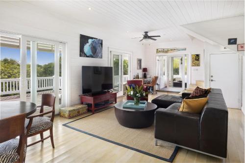 a living room with a couch and a table at Miranda House home in Governorʼs Harbour