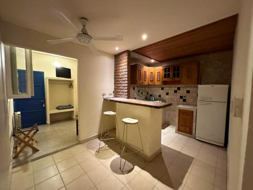 a kitchen with a counter and a refrigerator at Hotel ICONICO JUJUY Centro in San Salvador de Jujuy