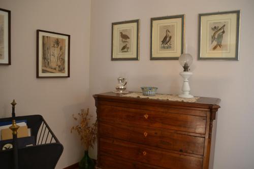 a room with a dresser and pictures on the wall at B&B VELARDI in Viagrande