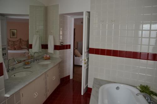 a bathroom with two sinks and a tub and a toilet at B&B VELARDI in Viagrande